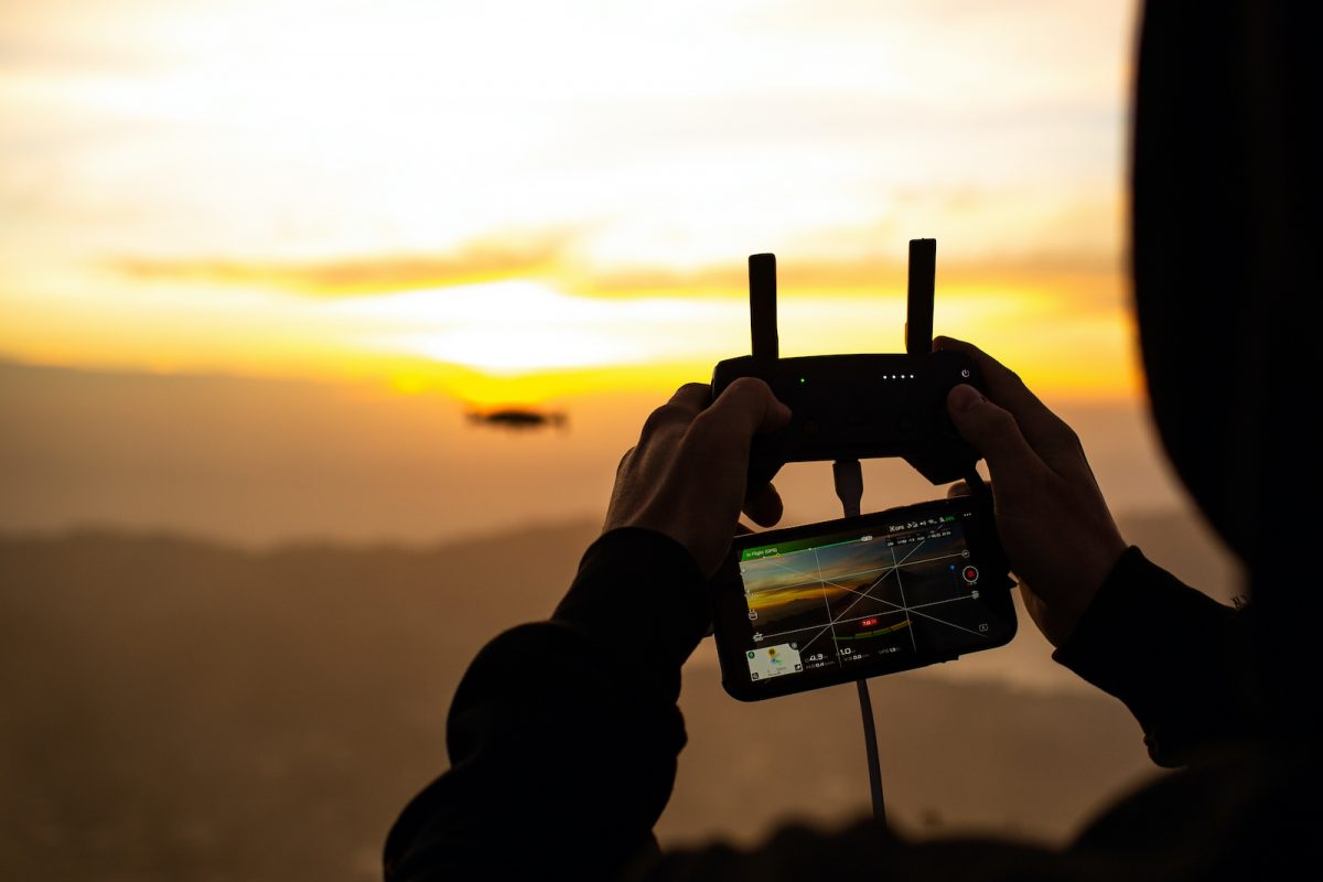 close up man controls drone in the dawn sun on the volcano batur bali indonesia