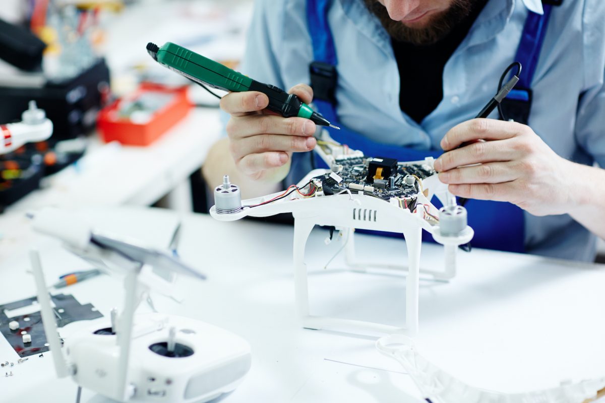 fixing drone in maintenance shop